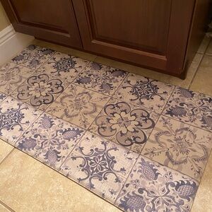 Cat Cora. 20 by 39 inches big. Anti fatigue mat. Use it anywhere.